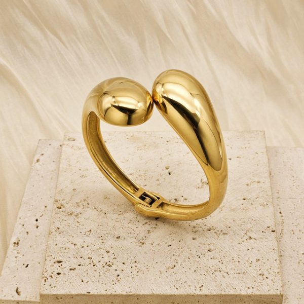 Geometric, glossy cross stainless steel bangle with asymmetric droplet double-headed design in INS style. - 图片 2